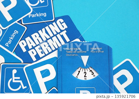 Parking permit paper notice tag and parking disc. Parking permit for people with disabilities concept 135921706