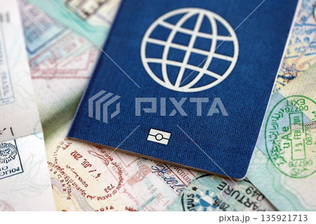 Many open passport pages with lots of visas and entrance stamps from various countries passport control. Concept of travel and tourism worldwide Many open passport pages with lots of visas and entrance stamps from various countries passport control. Concept of travel and tourism worldwide 135921713