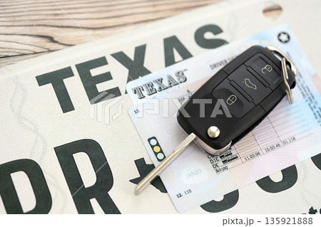 Remote control car keys on Texas license plate with driver license. Concept of driving in Texas. Reaching a driving permit 135921888