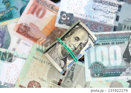 Egyptian pound currency money bills and bunch of us dollar banknotes close up. The concept of economics and currency exchange 135922279