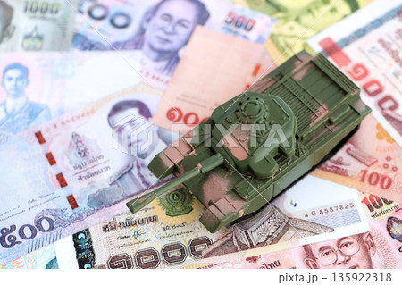 Thai baht currency money bills and toy tank close up. The concept of army funds and weapons sales 135922318