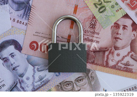 Thai baht currency money bills and padlock close up. The concept of sanctions and financial safety 135922319