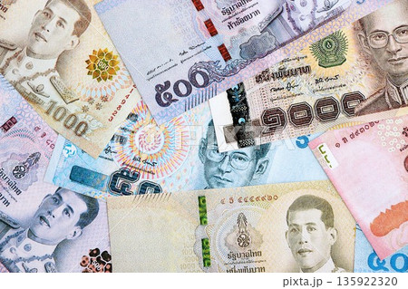 Thai baht currency money. The current banknotes lies on table in big amount close up 135922320