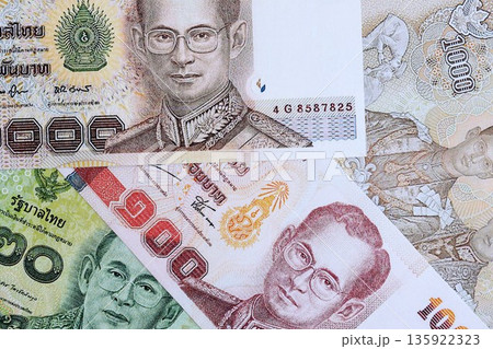 Thai baht currency money bills. The current banknotes lies on table in big amount close up 135922323