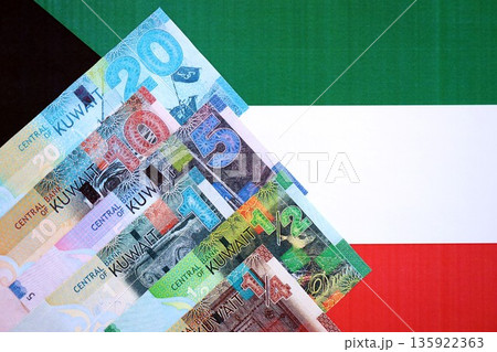 Kuwaiti dinar currency money bills lies on flag close up. The concept of business and investment 135922363