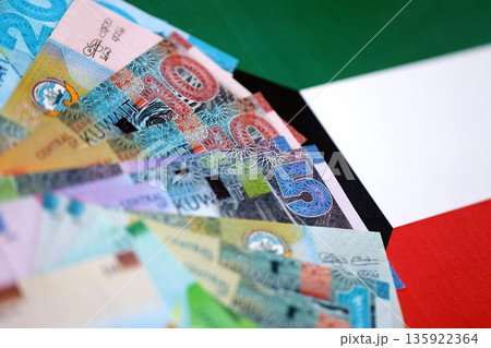 Kuwaiti dinar currency money bills lies on flag close up. The concept of business and investment 135922364