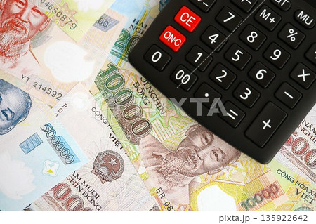 Vietnamese dong currency money bills and calculator close up. The concept of taxation and money count 135922642