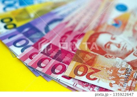 Philippines peso money bills in big amount close up on yellow. Finance and banking concept 135922647