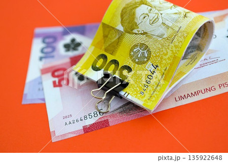 Philippines peso money bills in big amount close up on red. Finance and banking concept 135922648