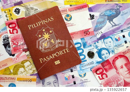 Philippines peso currency money bills and passport close up. The concept of travel and vacation 135922657