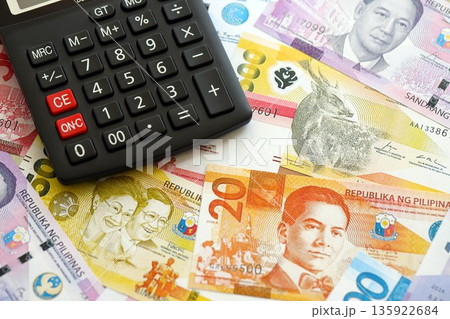 Philippines peso currency money bills and calculator close up. The concept of taxation and money count 135922684