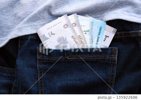 United Arab Emirates dirham money bills in denims pocket close up. The concept of fashion and wealth 135922686