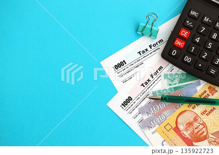 Nigerian naira money bills and calculator with tax form close up. Taxation and accounting concept 135922723