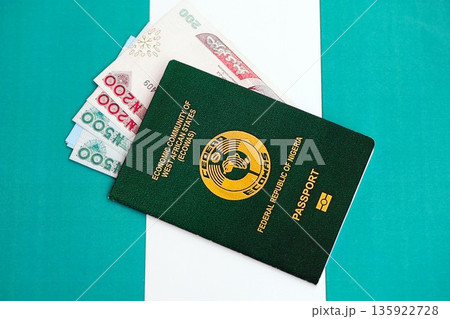 Nigerian naira currency money bills and passport lies on flag close up. The concept of travel and vacation 135922728