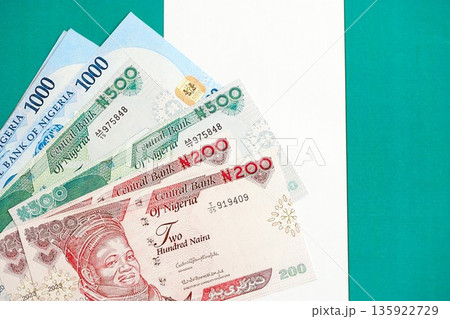 Nigerian naira currency money bills lies on flag close up. The concept of business and investment 135922729