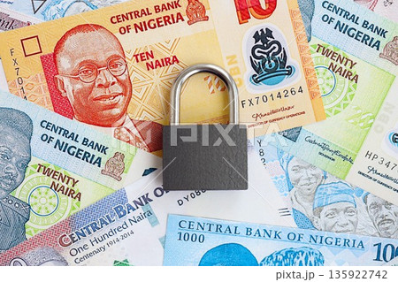 Nigerian naira currency money bills and padlock close up. The concept of sanctions and financial safety 135922742