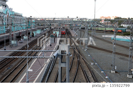 Railway tracks and trains on them. Rails in perspective. 135922799