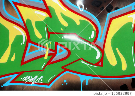 Colorful background of graffiti painting artwork with bright aerosol outlines on wall. Old school street art piece made with aerosol spray paint cans. Contemporary youth culture backdrop 135922997