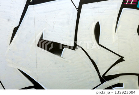 Colorful background of graffiti painting artwork with bright aerosol outlines on wall. Old school street art piece made with aerosol spray paint cans. Contemporary youth culture backdrop 135923004