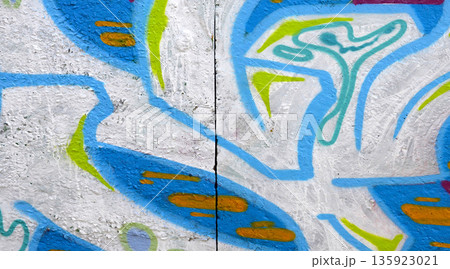 Colorful background of graffiti painting artwork with bright aerosol outlines on wall. Old school street art piece made with aerosol spray paint cans. Contemporary youth culture backdrop 135923021