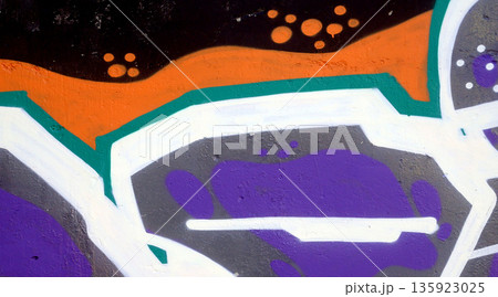 Colorful background of graffiti painting artwork with bright aerosol outlines on wall. Old school street art piece made with aerosol spray paint cans. Contemporary youth culture backdrop 135923025