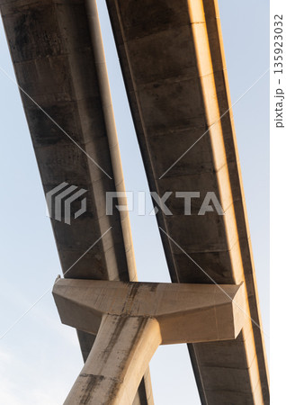 Low angle view of concrete elevated expressway structure against sky Low angle view of concrete elevated expressway structure against sky 135923032
