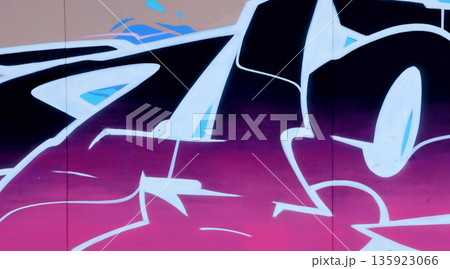 Colorful background of graffiti painting artwork with bright aerosol outlines on wall. Old school street art piece made with aerosol spray paint cans. Contemporary youth culture backdrop 135923066