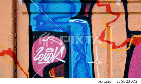 Colorful background of graffiti painting artwork with bright aerosol outlines on wall. Old school street art piece made with aerosol spray paint cans. Contemporary youth culture backdrop 135923072