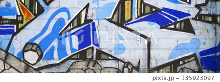 Colorful background of graffiti painting artwork with bright aerosol outlines on wall. Old school street art piece made with aerosol spray paint cans. Contemporary youth culture backdrop 135923097