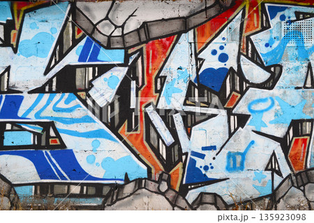 Colorful background of graffiti painting artwork with bright aerosol outlines on wall. Old school street art piece made with aerosol spray paint cans. Contemporary youth culture backdrop Colorful background of graffiti painting artwork with bright aerosol outlines on wall. Old school street art piece made with aerosol spray paint cans. Contemporary youth culture backdrop 135923098