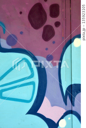 Colorful background of graffiti painting artwork with bright aerosol outlines on wall. Old school street art piece made with aerosol spray paint cans. Contemporary youth culture backdrop 135923105