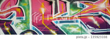 Colorful background of graffiti painting artwork with bright aerosol outlines on wall. Old school street art piece made with aerosol spray paint cans. Contemporary youth culture backdrop 135923108