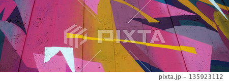Colorful background of graffiti painting artwork with bright aerosol outlines on wall. Old school street art piece made with aerosol spray paint cans. Contemporary youth culture backdrop 135923112