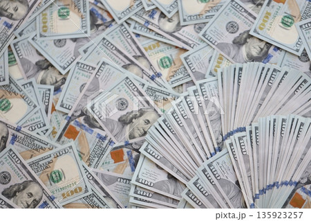 Very big amount of US hundred dollar bills close up. Huge quantity of united states currency notes on flat table Very big amount of US hundred dollar bills close up. Huge quantity of united states currency notes on flat table 135923257
