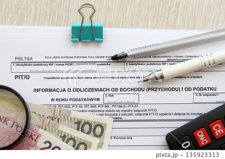 Information about deductions from income and tax, PIT-O form on accountant table with pen and polish zloty money bills close up 135923313