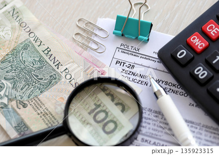 Declaration of amount of income obtained, amount of deductions made and lump sum due from recorded income, PIT-28 form on accountant table with pen and polish zloty money bills close up Declaration of amount of income obtained, amount of deductions made and lump sum due from recorded income, PIT-28 form on accountant table with pen and polish zloty money bills close up 135923315