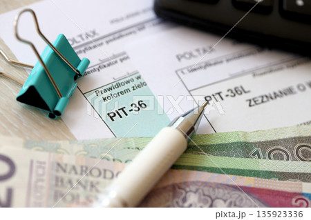Declaration of the amount of earned income or incurred loss, PIT-36 and PIT-36L tax forms on accountant table with pen and polish zloty money bills close up Declaration of the amount of earned income or incurred loss, PIT-36 and PIT-36L tax forms on accountant table with pen and polish zloty money bills close up 135923336
