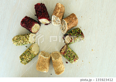 Rolls of turkish delight with different flavors and fillings close up on table. Turk Lokumu bars 135923412