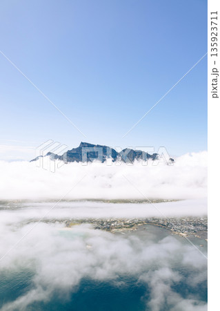 Aerial view of Table Mountain above clouds in Cape Town. Scenic helicopter tour over South Africa for travel and luxury vacation. Aerial view of Table Mountain above clouds in Cape Town. Scenic helicopter tour over South Africa for travel and luxury vacation. 135923711