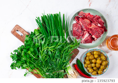 ingredients for cooking chakapuli, canned tkemali, meat, herbs Georgian cuisine, top view, ingredients for cooking chakapuli, canned tkemali, meat, herbs Georgian cuisine, top view, 135923793