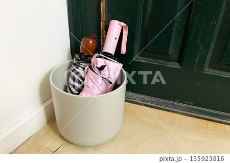 Umbrellas in a Stand by the Entryway Door Umbrellas in a Stand by the Entryway Door 135923816
