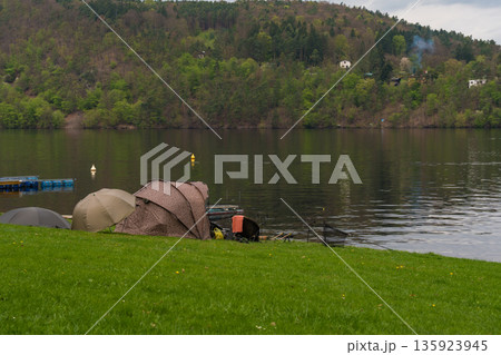 Fishing tents and rods on riverbank at Nova Zivohost, Czech Republic 135923945