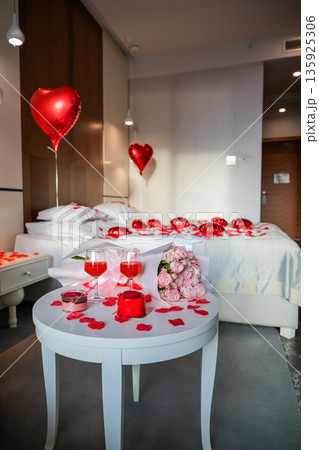 Vertical View of Table with Glasses Desserts and Roses with Decorated Bed Vertical View of Table with Glasses Desserts and Roses with Decorated Bed 135925306