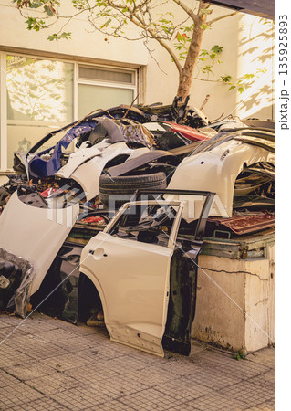 Automotive Scrap, Recycling Site. Scrap car parts and vehicle bodies at recycling site. Pile of discarded car parts, damaged vehicle bodies at outdoor recycling site. Automotive waste, metal recycling Automotive Scrap, Recycling Site. Scrap car parts and vehicle bodies at recycling site. Pile of discarded car parts, damaged vehicle bodies at outdoor recycling site. Automotive waste, metal recycling 135925893