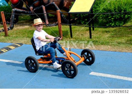 boy driving quad bike, four wheel cycle car, spring brightly morning, sunny day. High quality photo boy driving quad bike, four wheel cycle car, spring brightly morning, sunny day. High quality photo 135926032