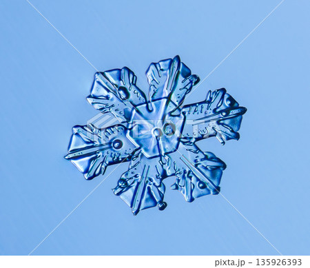 Natural snowflake crystal in blue background Natural snowflake crystal in blue background 135926393