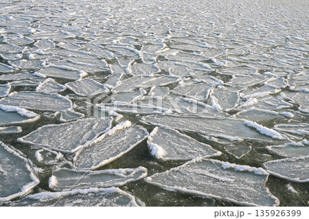 Floating ice floes forming natural patterns on the frozen Baltic Sea surface in Liepaja, Latvia Floating ice floes forming natural patterns on the frozen Baltic Sea surface in Liepaja, Latvia 135926399