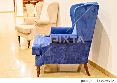 Sofa upholstered in blue with rolled-up arms	 135926512