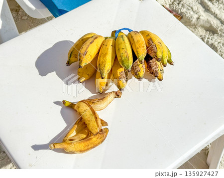 Peeled Banana On Beach Table Peeled Banana On Beach Table 135927427