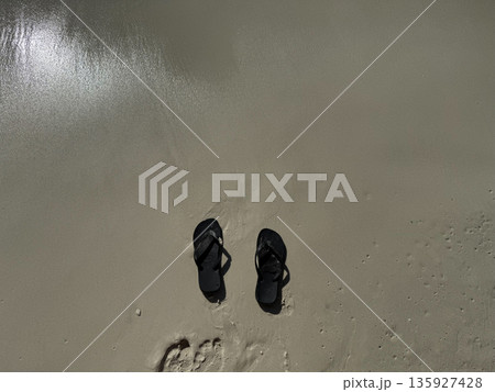 Flip Flops on Wet Sand Beach Flip Flops on Wet Sand Beach 135927428
